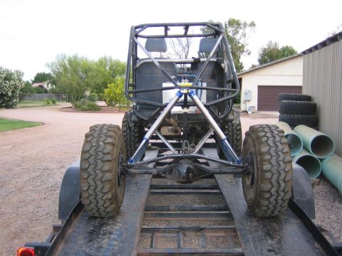 1987 Suzuki Samurai - Custom buggy with heavy-duty suspension and roll cage is loaded onto a trailer.