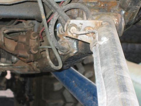 1987 Suzuki Samurai - Close-up view of the undercarriage components, showing brake lines and a shock absorber.