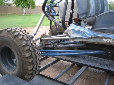 1987 Suzuki Samurai - This off-road buggy features large, aggressive tires and a prominent blue suspension system, suggesting custom modifications.