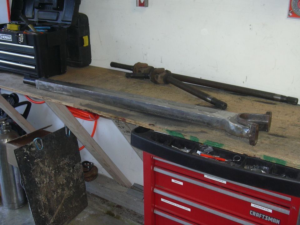 Radius arms and drive shafts on a workbench