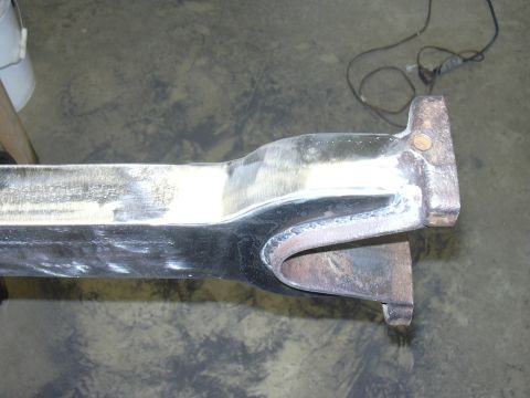1991 Ford Bronco - A close-up view of a metal suspension component, likely a radius arm, showing signs of repair and modification.