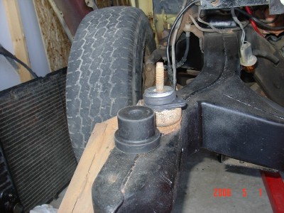 1972 Ford Ranchero - Close-up view of front suspension components, including a tire and radiator, on what appears to be a vehicle chassis.