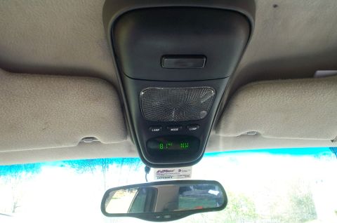 1999 Ford Crown Victoria - Interior overhead console with black plastic housing, dome/map light dome, two LAMP buttons flanking a MODE button, and a green digital dis…