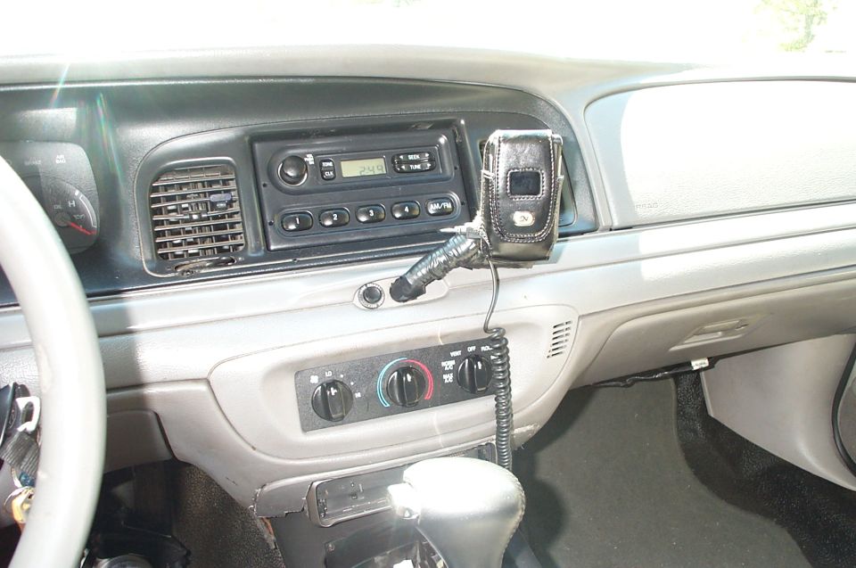 Gray Crown Victoria interior dash with radio, climate controls, and mounted phone holder