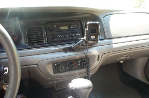 1999 Ford Crown Victoria - Interior view of a Ford Crown Victoria dashboard showing the gray center console with an AM/FM radio displaying '245', rotary climate contr…