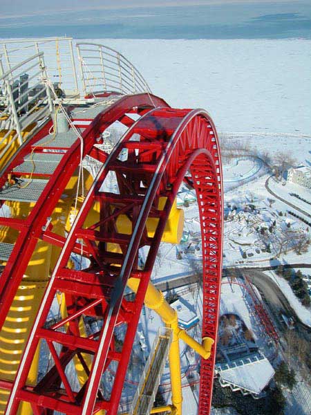1968 Ford Mustang - Roller coaster track curves over a snowy amusement park and a frozen body of water.