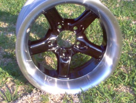 1986 Ford Bronco - Close-up of a five-spoke aftermarket wheel with a polished lip.