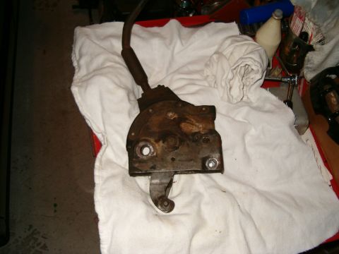 1979 Ford Bronco - A close-up view of a rusted metal lever mechanism, likely a vehicle part, resting on a white cloth.