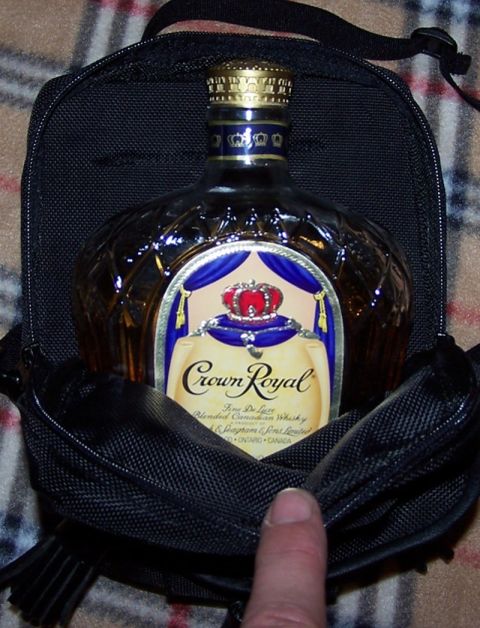 1990 Ford Bronco - A bottle of Crown Royal whisky is shown inside a black protective pouch.