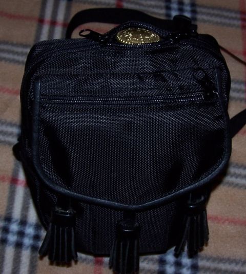 1990 Ford Bronco - This black pouch features decorative tassels and a gold emblem, not a 1990 Ford Bronco.
