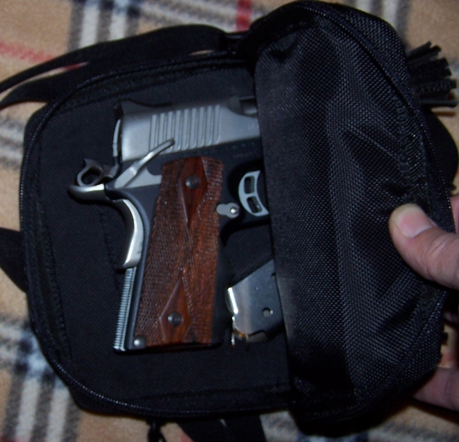 Pistol with wooden grips and magazine in a black bag