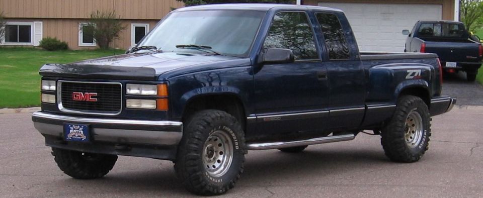 Dark blue 1995 GMC Sierra 1500 pickup truck with Z71 badging, lifted suspension, and aftermarket wheels
