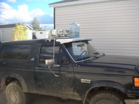 1989 Ford Bronco - This 1989 Ford Bronco is equipped with auxiliary lights and carries a large water jug on its roof rack.