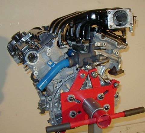 1995 Ford Probe - This engine is mounted on a red stand, ready for work or display.