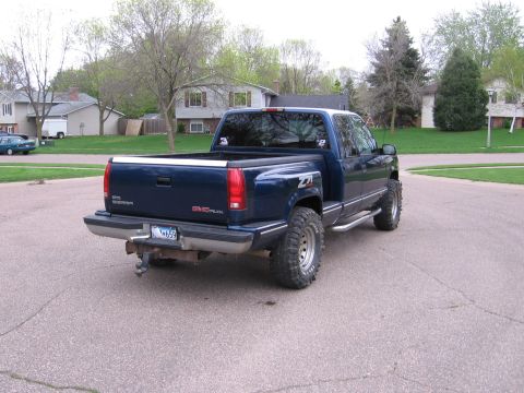 1995 GMC Sierra 1500 - This 1995 GMC Sierra 1500 pickup truck is shown from the rear, Z71 badging and large off-road tires.