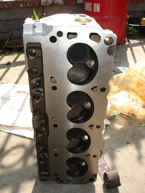1989 Lincoln Continental - A close-up view of an engine cylinder head, showing the intake valves and ports.