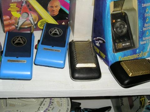 1984 Pontiac Fiero - Collection of Star Trek communicators and a tricorder displayed on a shelf.