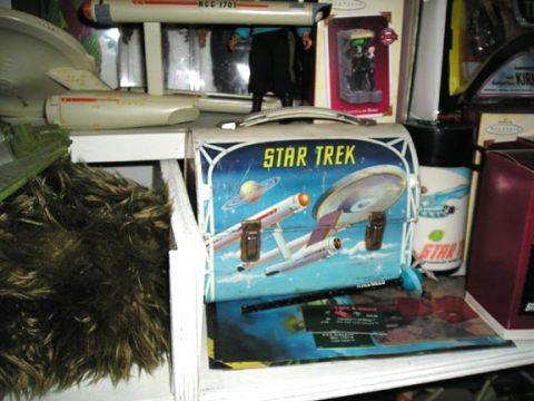 1984 Pontiac Fiero - Collection of Star Trek items including a lunchbox, model ship, and figurines displayed on a shelf.