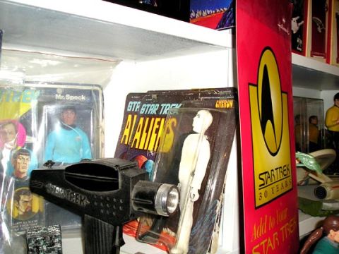 1984 Pontiac Fiero - A collection of Star Trek merchandise, a phaser toy, action figures, and a 30th-anniversary banner.
