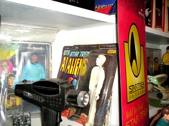 Star Trek phaser toy in foreground with Mr. Spock action figure and Star Trek 30 Years banner