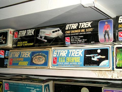 1984 Pontiac Fiero - Various Star Trek model kits are organized on shelves, depicting spacecraft and characters from the franchise.