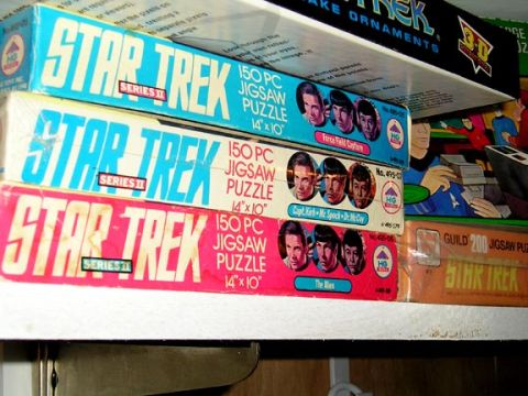 1984 Pontiac Fiero - Several Star Trek jigsaw puzzle boxes are stacked on a shelf, characters from the show.