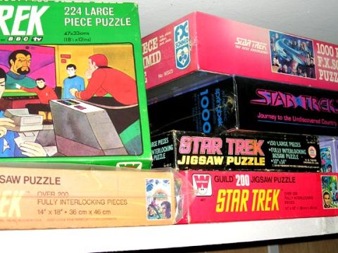 1984 Pontiac Fiero - A collection of Star Trek themed jigsaw puzzles are displayed on shelves.