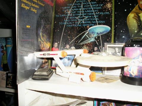 1984 Pontiac Fiero - A Starship Enterprise model, identified as NCC-1701, is displayed among Star Trek memorabilia.