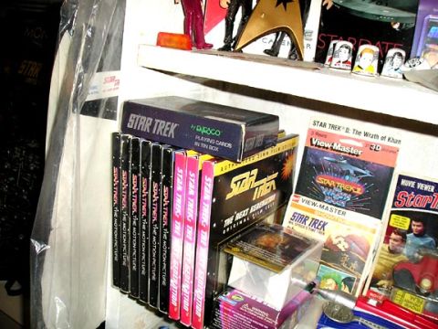 1984 Pontiac Fiero - Collection of Star Trek media and merchandise displayed on a shelf.