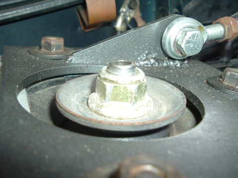 1993 Ford Taurus - Detail of a vehicle's suspension system, focusing on a strut mount assembly with hardware.