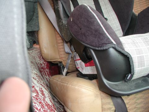1998 Jeep TJ - Interior view of a vehicle showing a child car seat and stained floor.