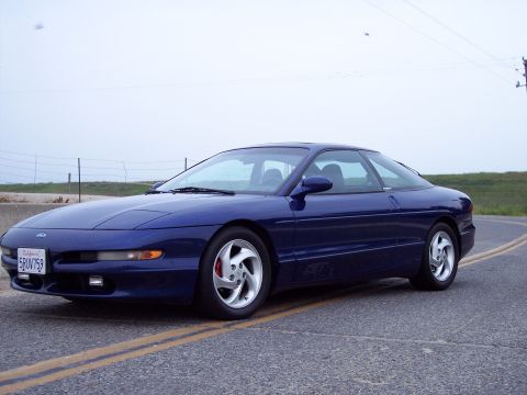1995 Ford Probe - A blue 1995 Ford Probe is shown from a three-quarter front angle on a paved road.