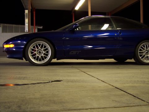 1995 Ford Probe - Side view of a blue 1995 Ford Probe GT, highlighting its aftermarket rims.