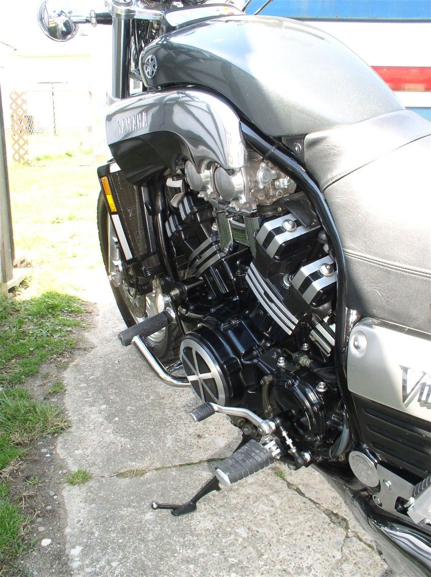 Left side engine detail of silver Yamaha V-Max motorcycle on driveway