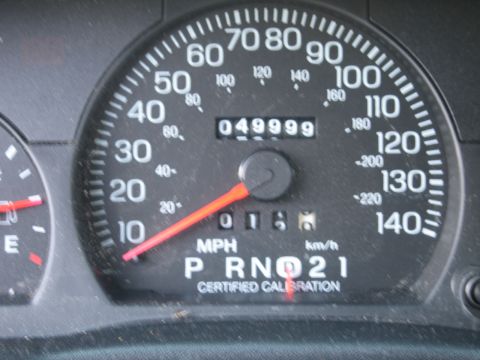 1991 Ford Crown Victoria LTD - Close-up of a car's instrument cluster, displaying speed and mileage.