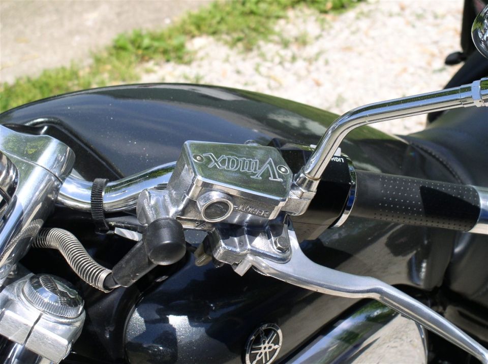Chrome Yamaha V-Max brake reservoir and handlebar over a black fuel tank