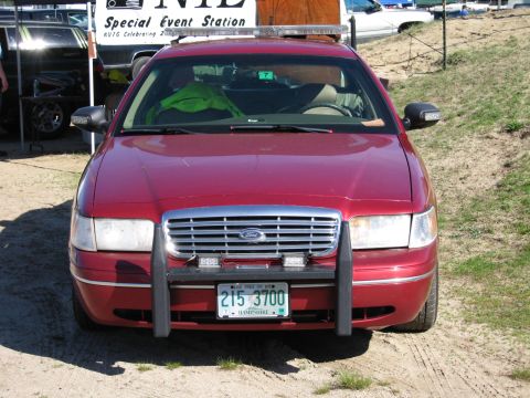 1991 Ford LTD Crown Victoria - Front view of a red Ford Crown Victoria equipped with a push bar and auxiliary lights.