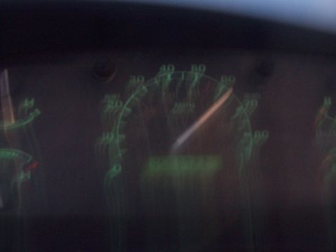 1994 Ford F-150 - Blurred night shot of a truck instrument cluster lit by green backlighting, with the needle sweeping past 60 on the 80 MPH speedometer. Cam…