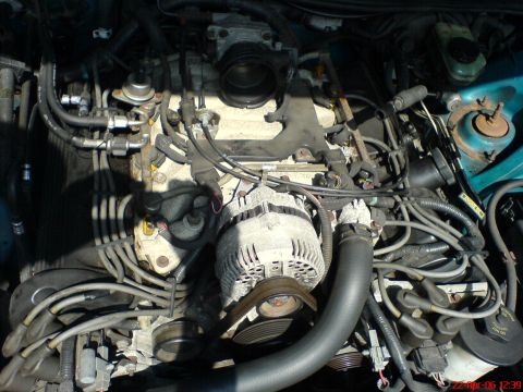 1994 Ford Thunderbird - A detailed view of the engine compartment, highlighting the complex network of mechanical parts and wiring.