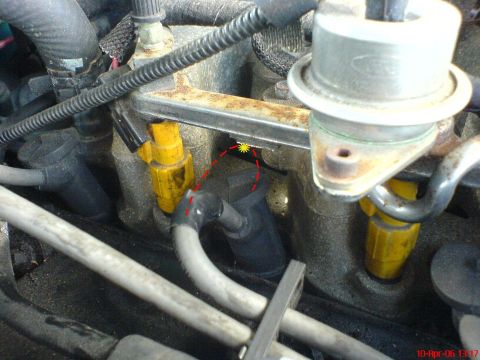 1994 Ford Thunderbird - This image shows a close-up view of engine components, specifically fuel injectors and part of the fuel rail.