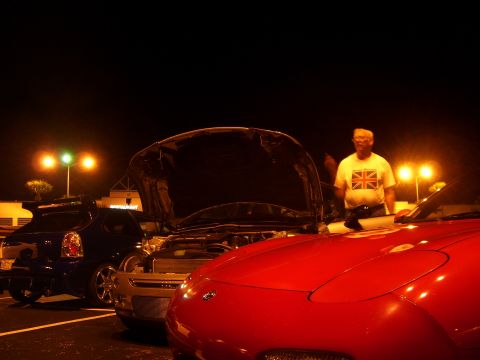 1994 Ford Probe - Cars parked at night with one hood open, a man in a Union Jack shirt is visible.