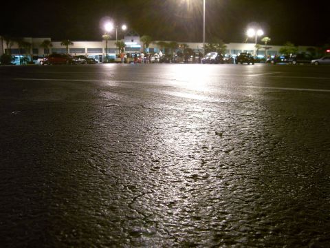 1994 Ford Probe - A nighttime scene captures a parking lot with several vehicles parked in the distance.