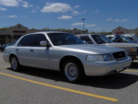 2002 Ford Crown Victoria - Silver 2002 Ford Crown Victoria parked in a shopping center lot under a blue sky.
