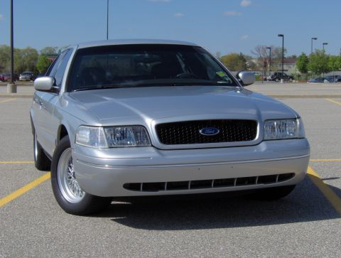 2002 Ford Crown Victoria - A silver 2002 Ford Crown Victoria is shown from the front in a parking lot.