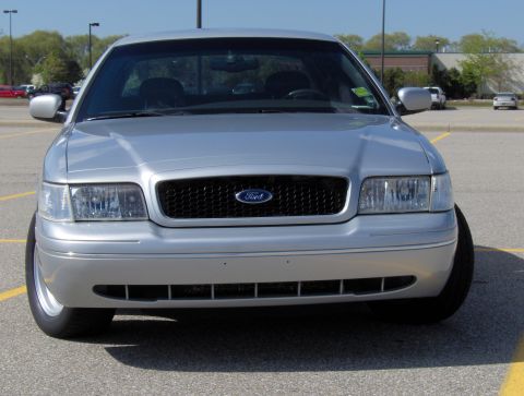 2002 Ford Crown Victoria - Front view of a silver 2002 Ford Crown Victoria parked in a lot.