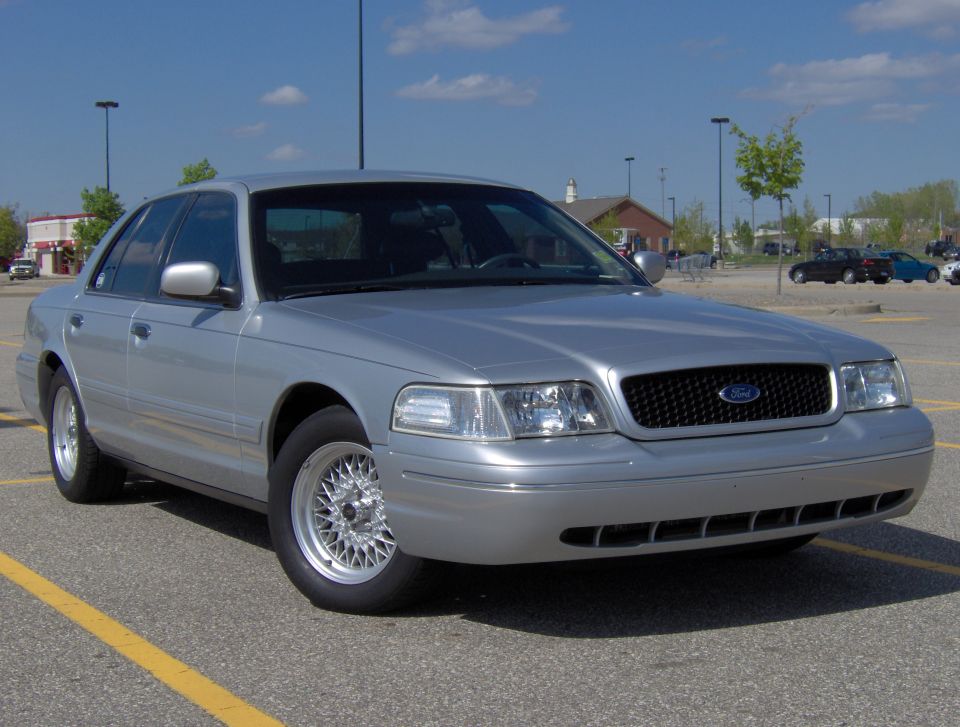 Silver 2002 Ford Crown Victoria parked in a lot, front 3/4 view, clean condition