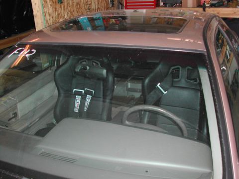 1993 Ford Thunderbird - Interior view of a car with racing seats and a sunroof.