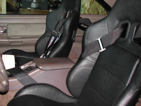 1993 Ford Thunderbird - The interior features racing seats with multi-point harnesses, replacing the original upholstery.
