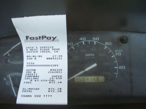 1994 Ford F-150 - A FastPay receipt from Jack's Service is shown next to the speedometer and odometer of a vehicle.