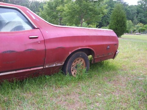 1972 Ford Ranchero - This 1972 Ford Ranchero shows signs of wear and tear, with rust visible on its side panels and rear fender.